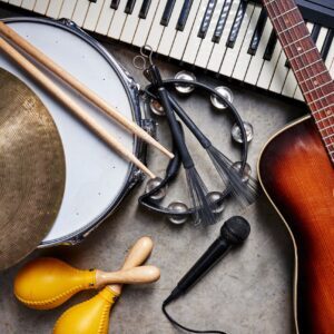 a group of musical instruments including a guitar, drum, keyboar